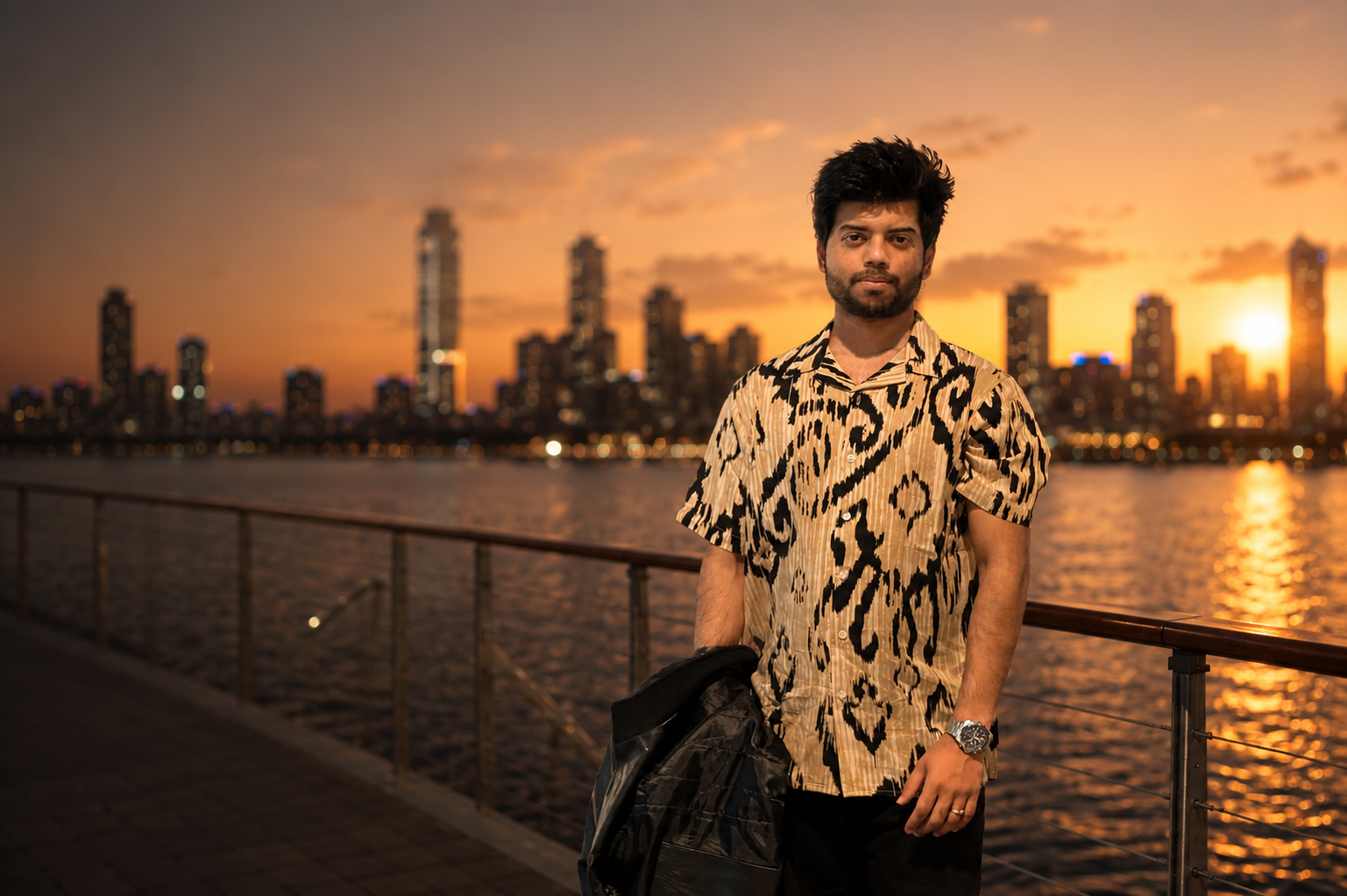 Anim Rahman standing by the waterfront with the city skyline at sunset